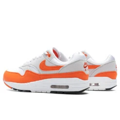Nike Women's Air Max 1 '87 'Safety Orange' - Neutral Grey/Safety Orange/White -Best Shoes Shop Nike Air Max 1 87 Women s Neutral Grey Safety Orange White DZ2628 002 10 08 23 Feature KN 5